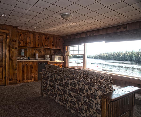 Couch in living room overlooking lake