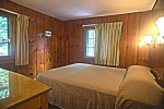 Bedroom with wood paneled walls