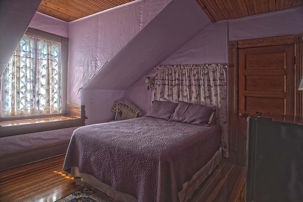 purple walled room with bed